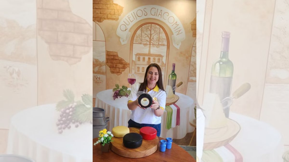 Gabriela Giacomin, que assumiu a loja com seu marido Pedro, mostra queijos produzidos pela família — Foto: Divulgação